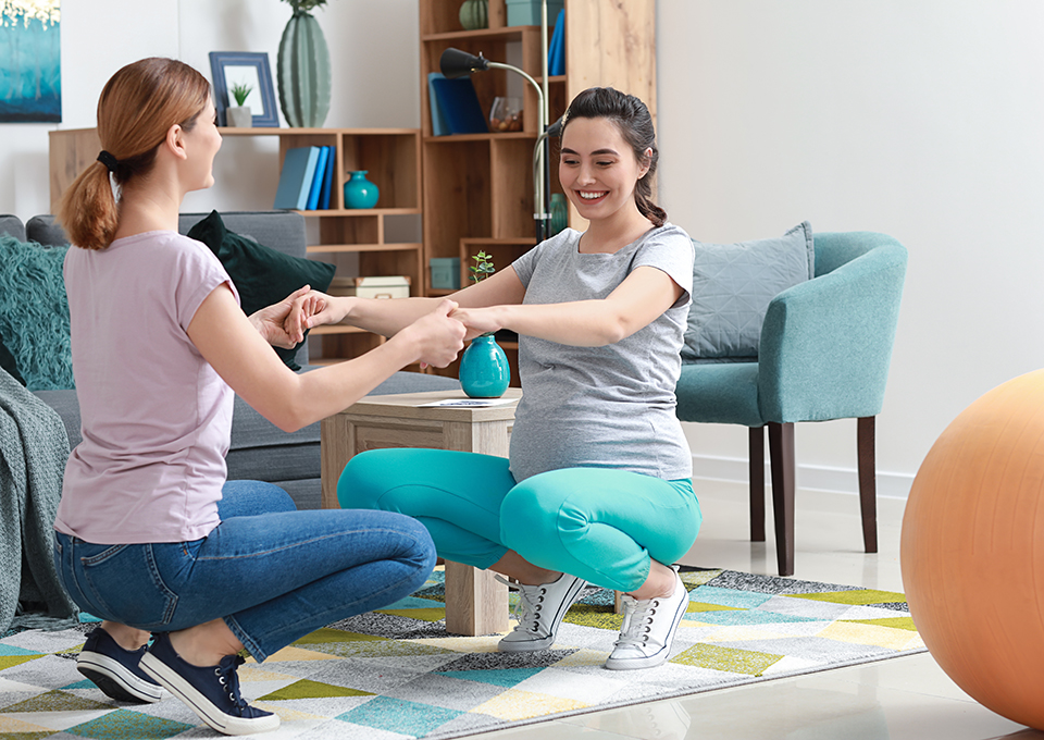 Doula providing prenatal support and guidance to expectant mother